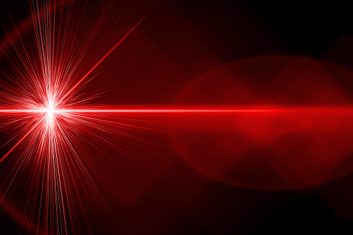 A red bright laser ray on black background