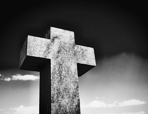 istock Stark stone cross against sky is a reminder of mortality 511515514