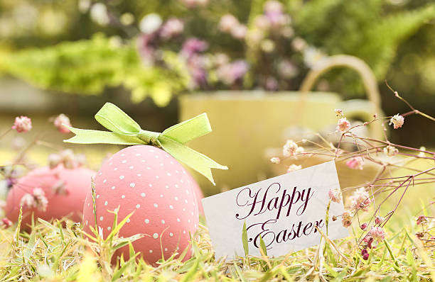 istock pink eggs with flowers and card in grass 511515810
