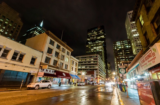 San Francisco, California, United States of America - March 1, 2014: Night view of San Francisco Chinatown in northern California, United States of America. A view of the cityscape, city skyscrapers, illuminated streets and Chinese signs over the shops.