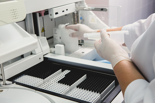 Loading Sample Into Gc Machine Lab Tech Loading Samples Into A Chemistry Analyzer Stock Photo ...