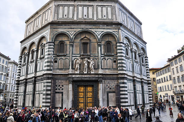 Florence, Italy - November 10, 2010: St. Giovanni Baptistery, tourists enjoy sightseeing.