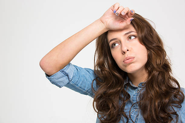 istock Sad tired young woman with hand on forehead 511522666