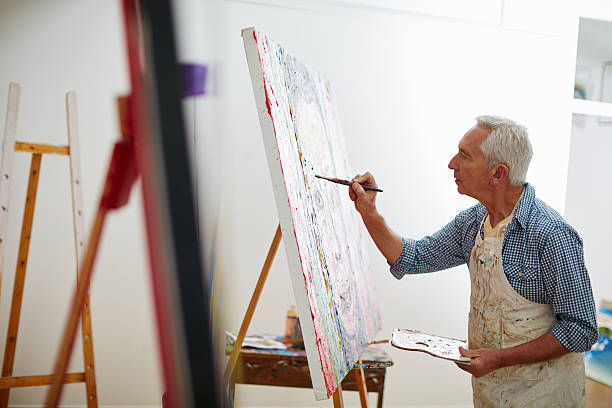 Makers gonna make Shot of a senior man working on a painting at homehttp://195.154.178.81/DATA/i_collage/pu/shoots/806388.jpg art class photos stock pictures, royalty-free photos & images