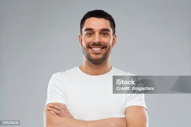 Smiling Man With Crossed Arms Over Gray Background Stock Photo - Download Image Now - Men, Latin American and Hispanic Ethnicity, Cut Out