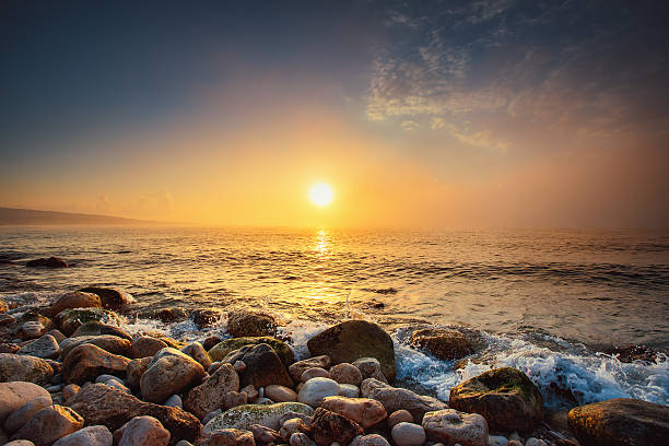 istock Tropical colorful sunrise at the stones beach. 511526894