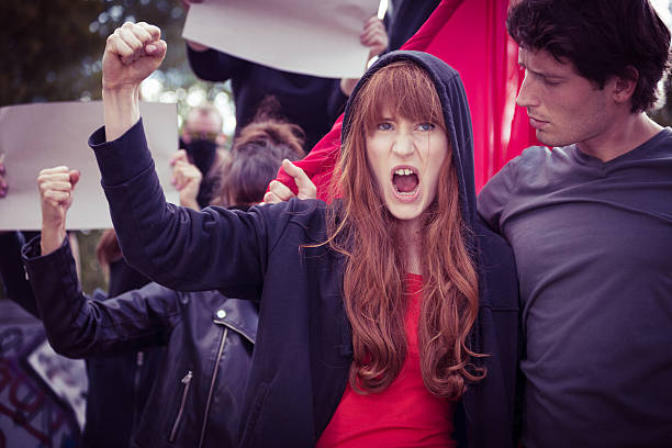 istock Female protester with raised fist 511527062