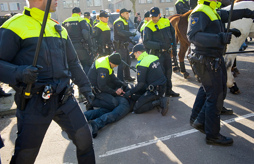Enschede, The Netherlands - February 13, 2016: A demonstrator against a huge migrant refugee camp for refugees is being arrested by policemen.