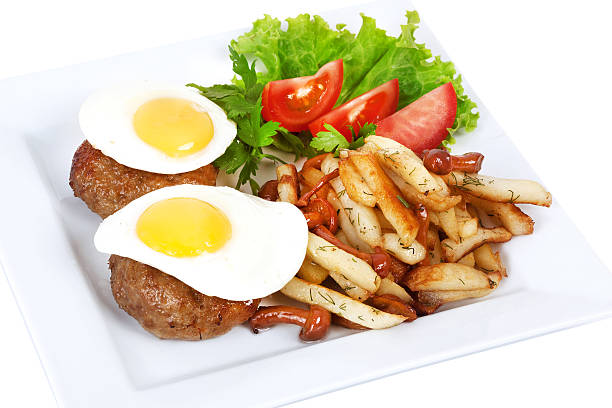 steak with egg, fries, tomato, lettuce stock photo