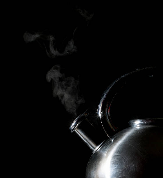 istock kettle whistling, boiling kettle, steam on a black background 511529274