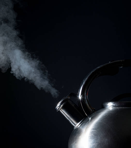 istock kettle whistling, boiling kettle, steam, on a black background 511529612
