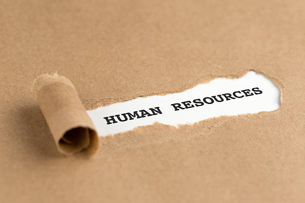 istock The text HUMAN RESOURCES appearing behind torn brown paper 511529704