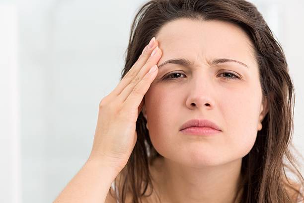 istock Girl examining her face skin 511531796