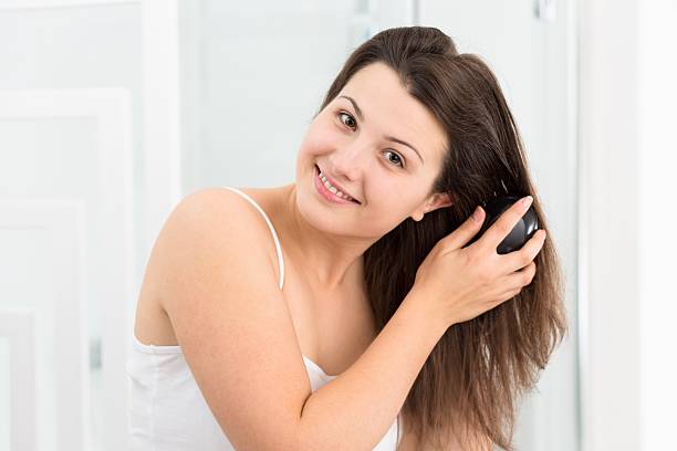 istock Woman combing her long hair 511531840