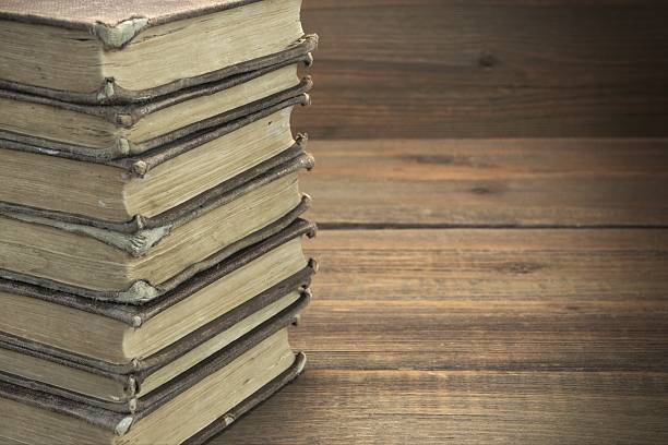 istock Old Shabby Books In Stack On The Wood Horizontal Background 511532836