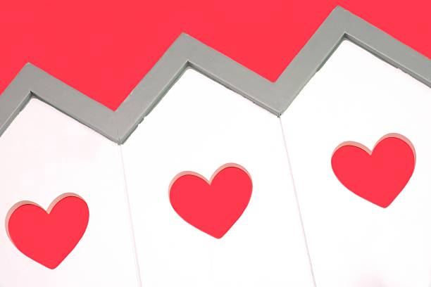 House Model With Windows In The Shape Of A Heart White Small House Wooden Model With Three Windows In The Shape Of A Heart Isolated On The Red Background, Close Up, Image, Concept menage trois stock pictures, royalty-free photos & images