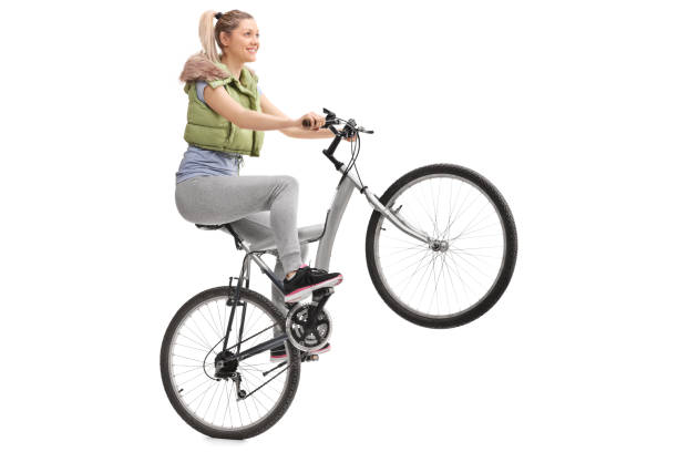 istock Young woman doing a wheelie on a bicycle 511533376
