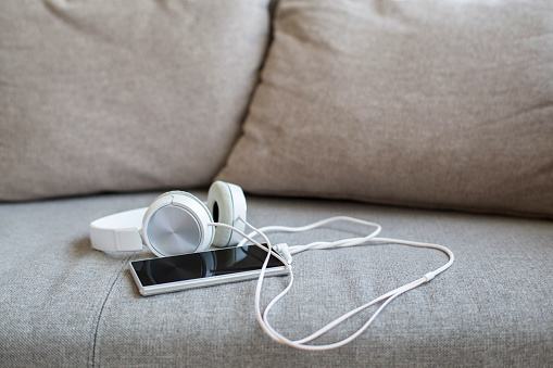 earphone and smart phone on sofa