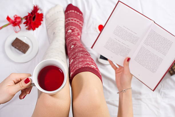 istock Woman having a cup of tea in bed 511533928