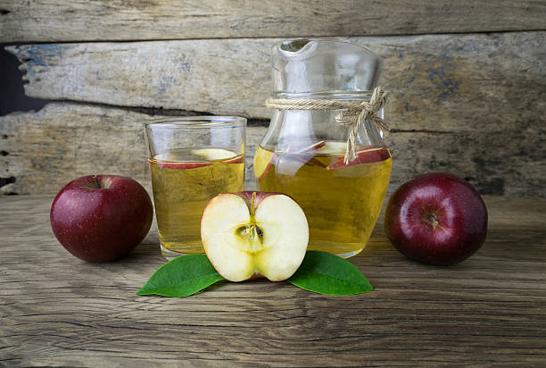 istock Apple juice and apples on a wooden table 511535568