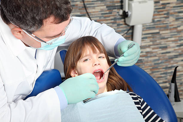 istock Male dentist and young patient 511536292