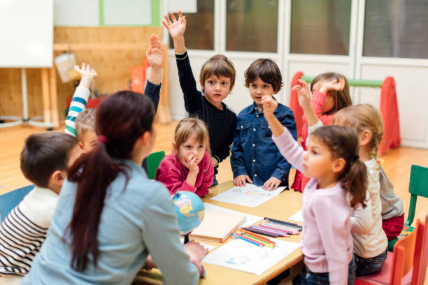 istock Preschool teacher and children in classroom 511537348