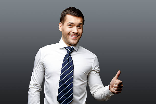 istock Handsome stylish businessman on grey background 511537564