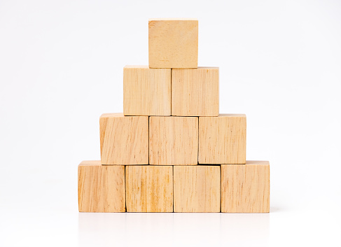 close up at wood cube arrange in pyramid shape ,business concept mock up.