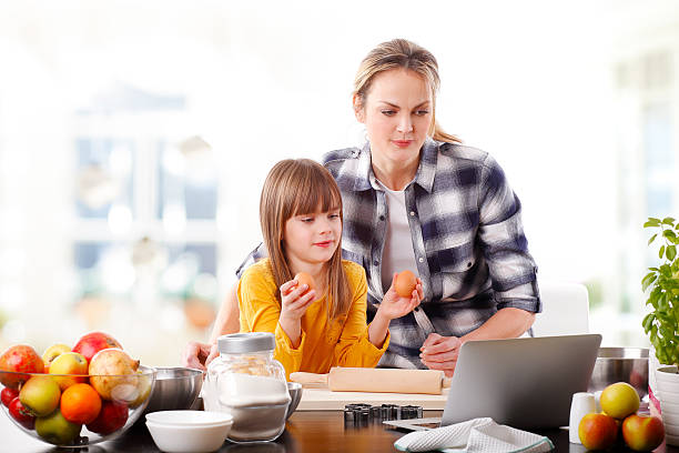 istock Mother and daugther baking together 511540244