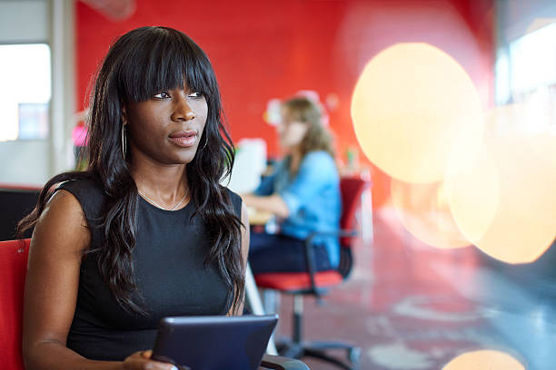 istock Confident female designer working on a digital tablet in red 511542028