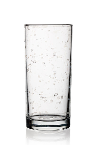 Empty dirty glass for water.It is caused by the presence of certain salts of calcium and magnesium.Isolated on white-Clipping path