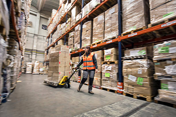 istock Woman moving boxes in a warehouse 511544280