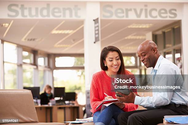 College Student Having Meeting With Tutor To Discuss Work Stock Photo - Download Image Now