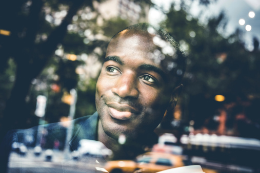 Portrait of a man on the window of a cafe in New York.