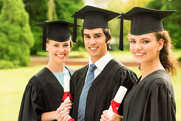 istock Happy Students Holding Diplomas On Graduation Day At Campus 511572363