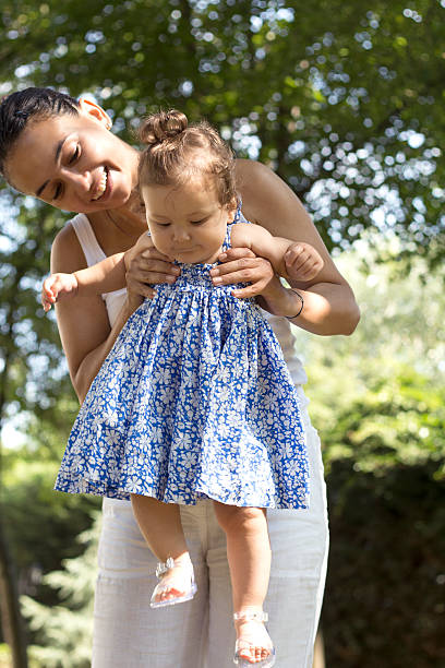 istock Mother Lifting Baby Girl 511572381