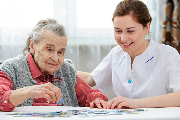 istock Senior woman with her elder care nurse 511574945