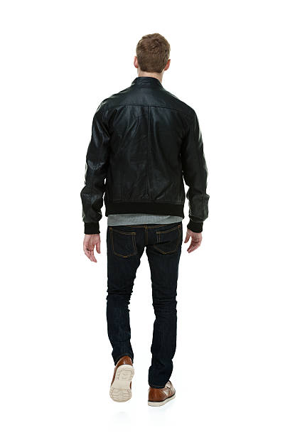 istock Rear view of man in jacket & walking 511578171