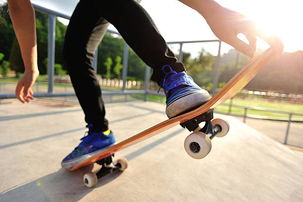 istock Legs in sneakers on a skateboard 511578345