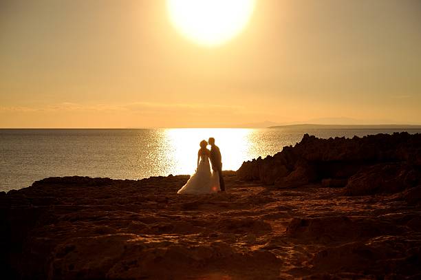 istock Bride and groom at sunset kissing. 511579056