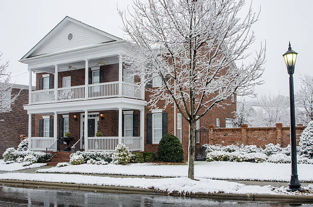 istock Traditional Brick Home During a Winter Snow Storm 511579220