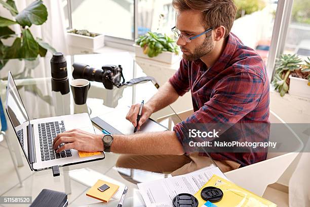 Young Professional Photographer Busy Working From His Home Studio Stock Photo - Download Image Now