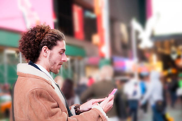 istock Man with cell phone in Times Square, New York City. 511581796