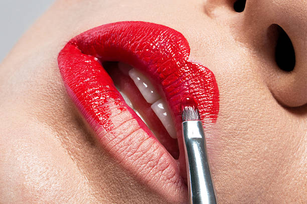 istock Beautiful shiny red lips as you paint brush 511583200