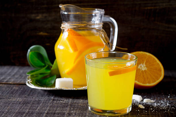 istock Adrink with fresh orange on a wooden table 511583934