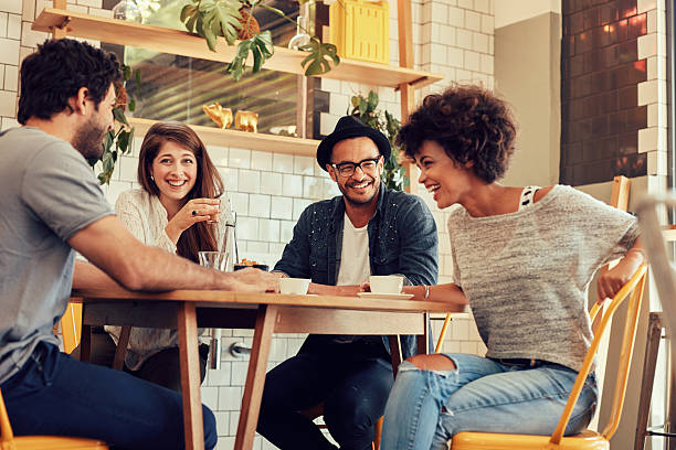 istock Cheerful young friends having fun in a cafe 511584214