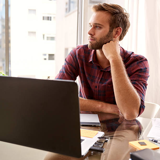 istock Young student lekking off camera at his desk 511585076