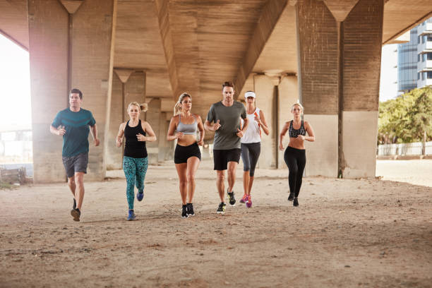 istock Healthy young people running together in city 511585554