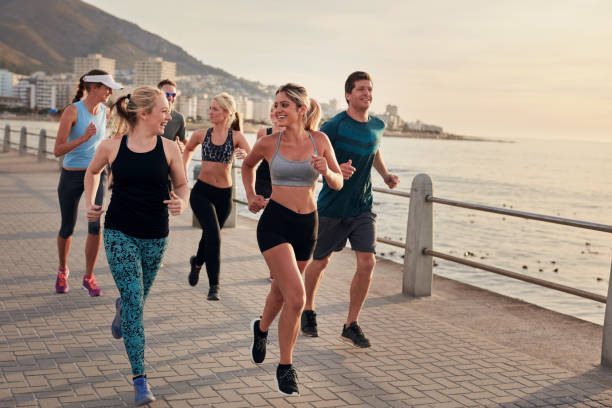 istock Group of athletes running along a seaside promenade 511586112