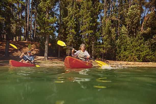 istock Mature couple canoeing on a lake during a camping trip 511586406